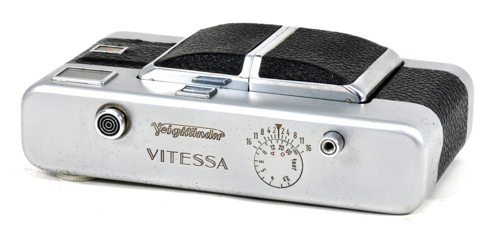 The camera folded, showing its depth of field scale on the top plate that operates as the lens is focused