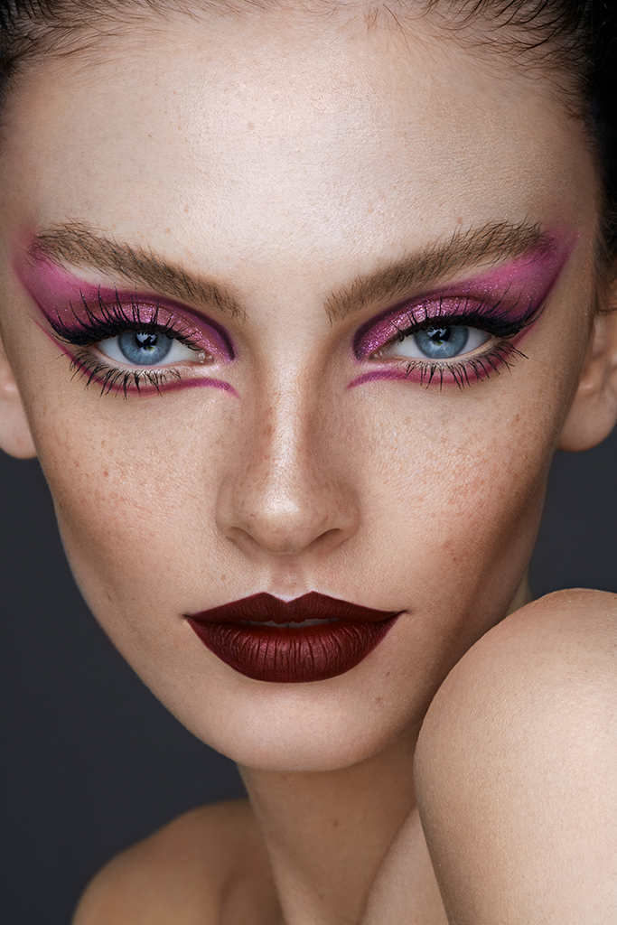 close-up portrait of a model with pink eyeliner