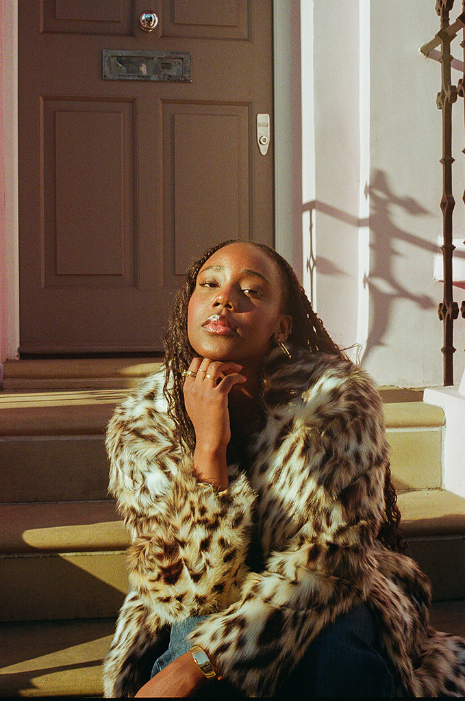 portrait of a girl sat on house steps