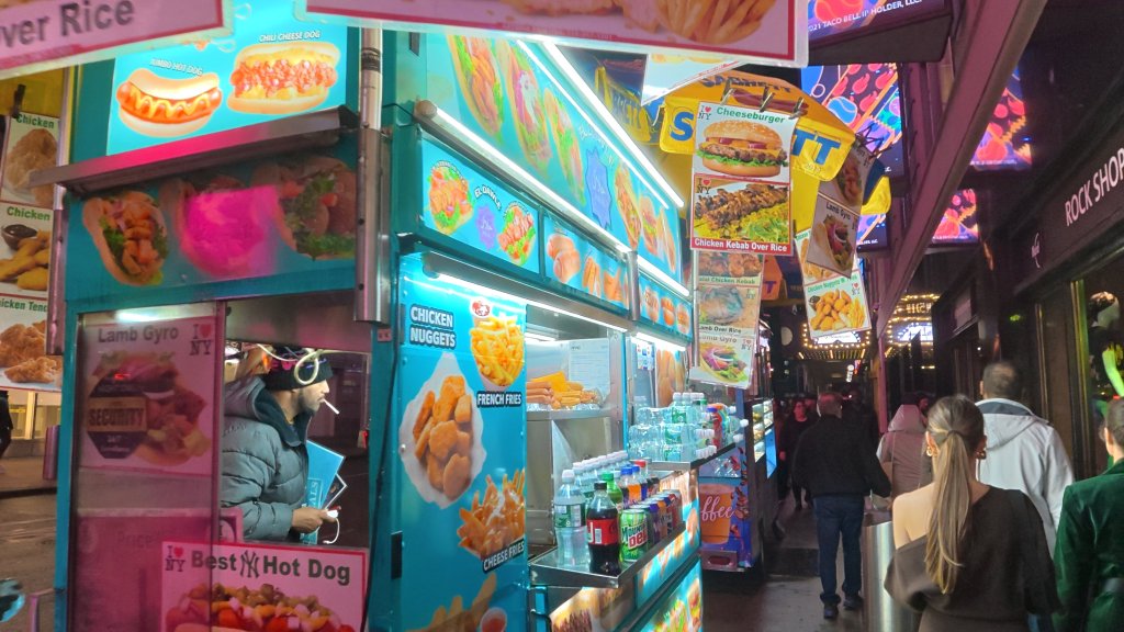 Sample image of DJI Osmo Action 6, showing night-time scene of a New York food cart
