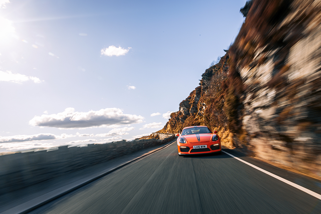 orange sports car in action