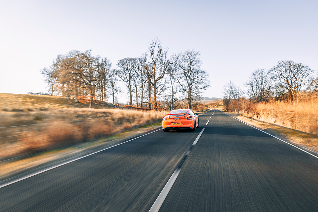 orange sports car in action