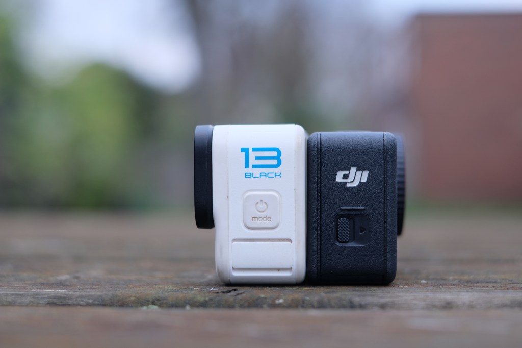 Photograph of GoPro Hero 13 Black and DJI Osmo Action 6 side view with logos visible