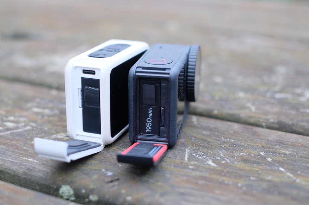 Photograph of GoPro Hero 13 Black and DJI Osmo Action 6 with battery compartments open