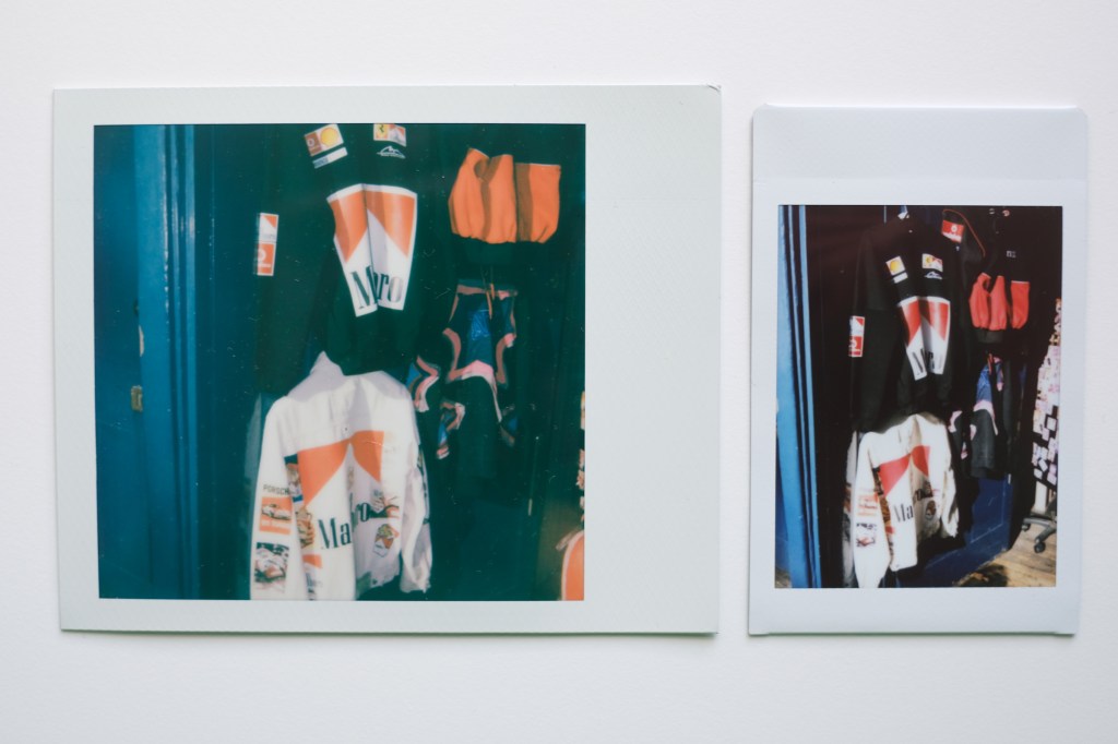 Polaroid I-Type and Instax Mini photos next to each other, showing Marlboro branded jackets hanging in shop doorway