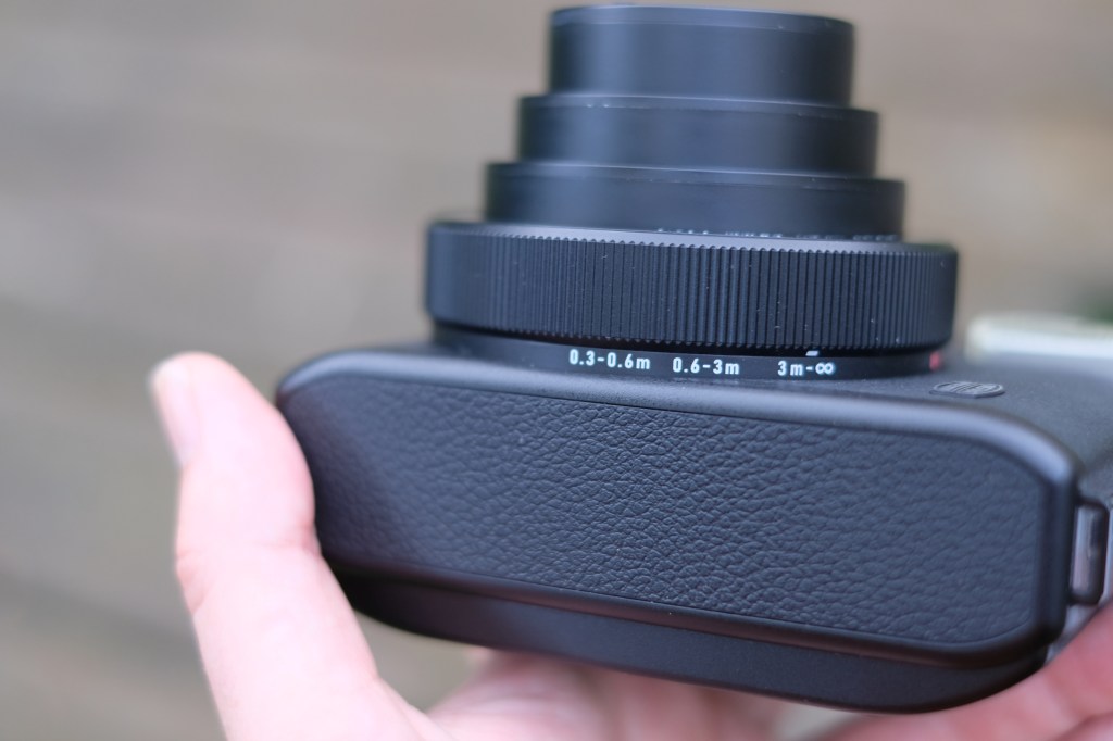 Photograph of Fujifilm Instax Mini 99 bottom showing focus distance scale