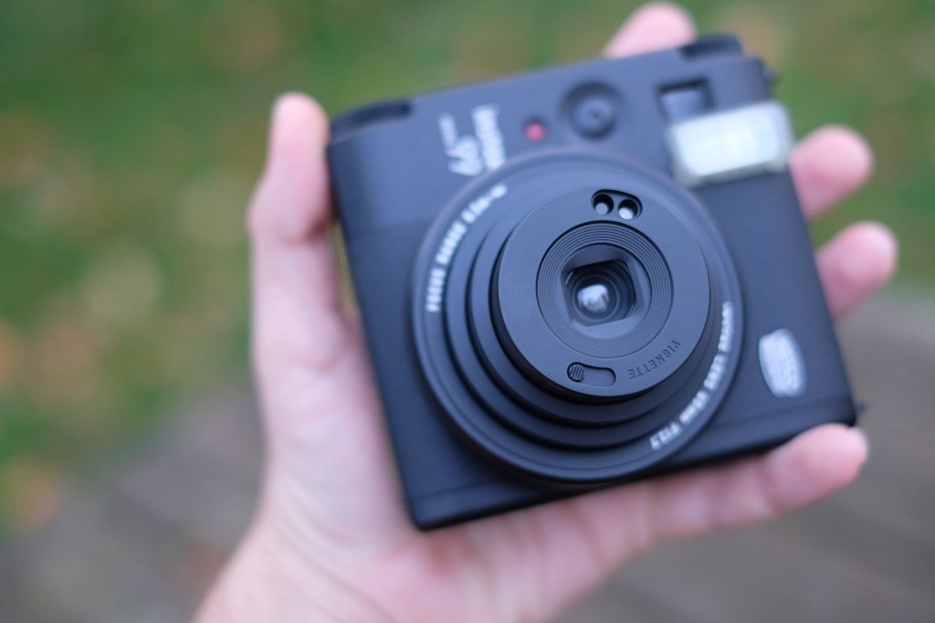 Fujifilm Instax Mini 99 photograph with lens protruding in focus