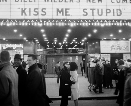 a couple kissing in front of a movie theatre new york