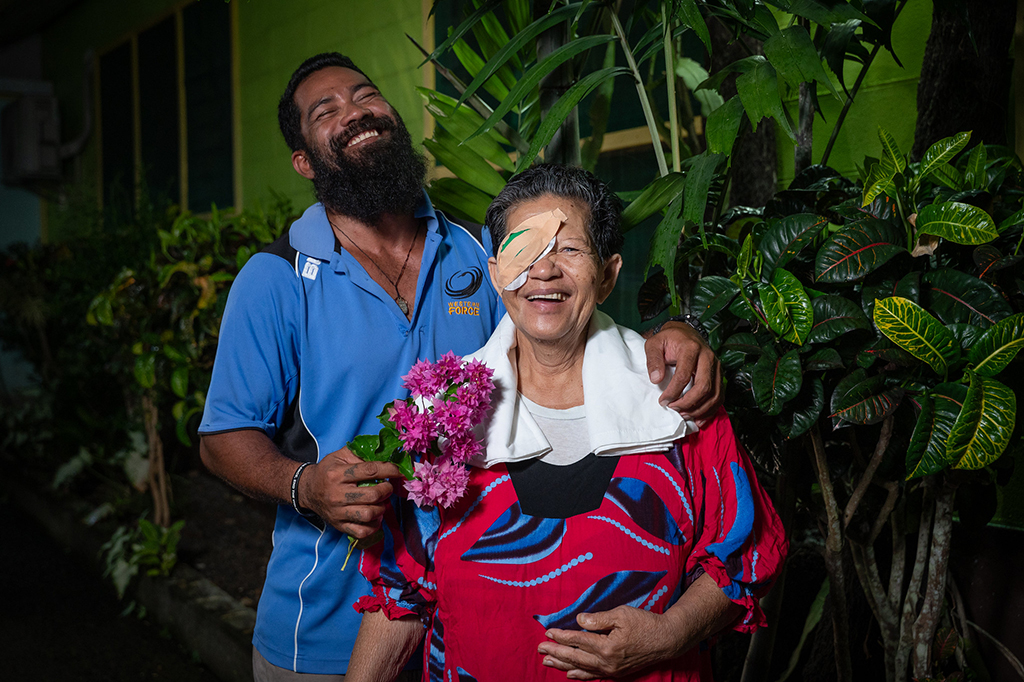 woman after eye surgery with her son smiling