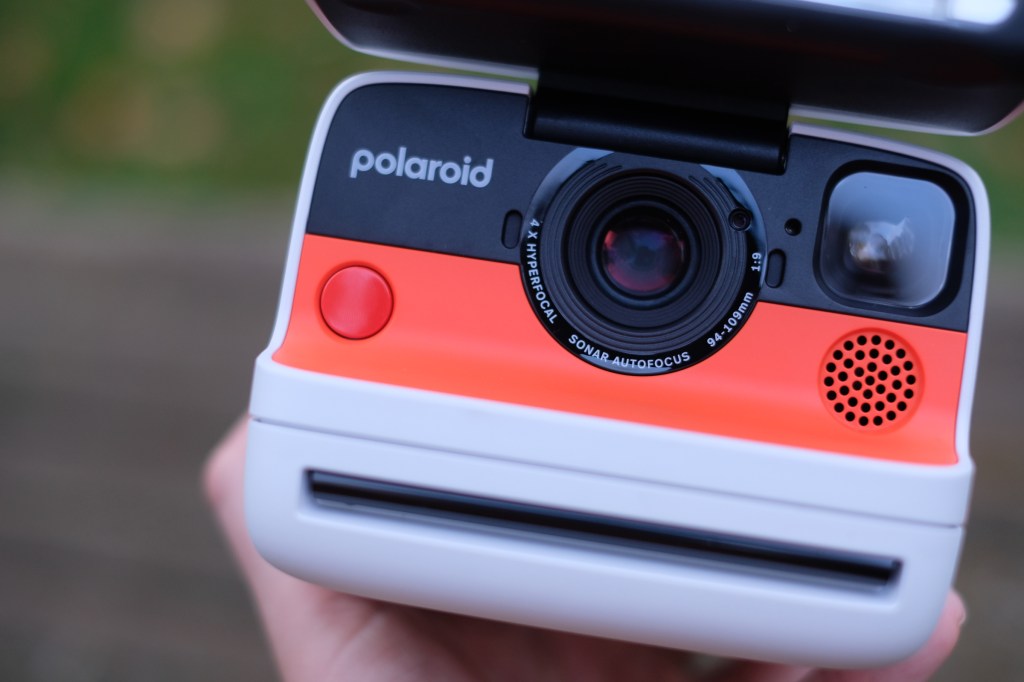 Close-up photograph of Polaroid Flip showing lens and shutter button
