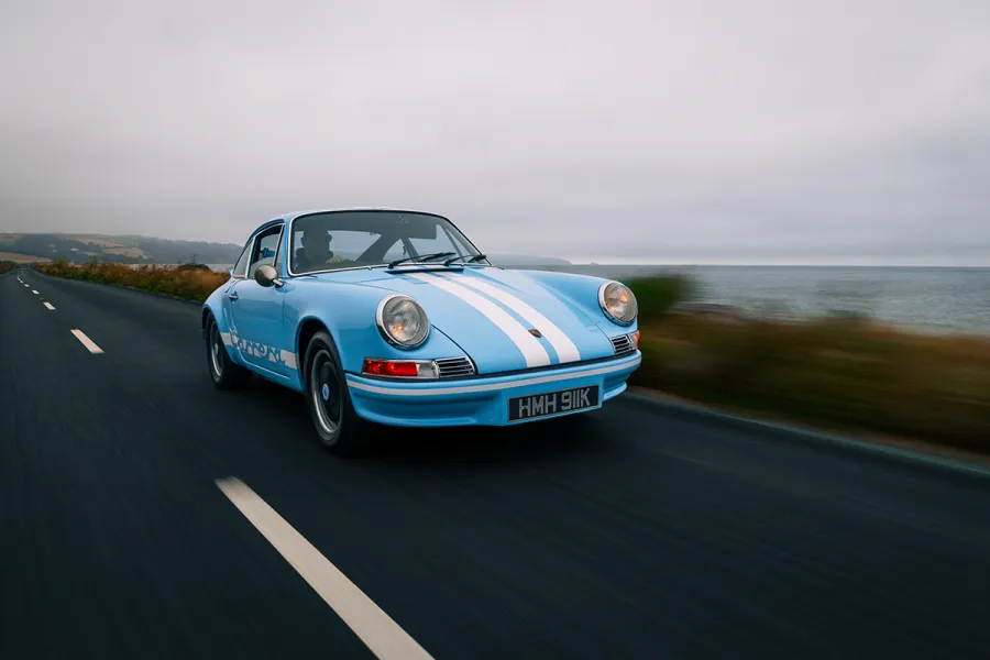 blue sports car in action