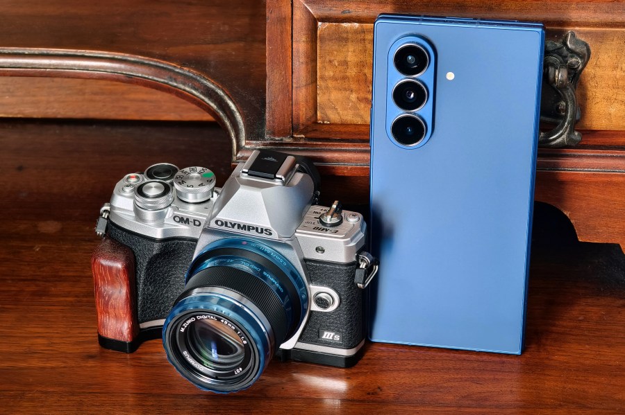 Olympus mirrorless next to the Samsung Galaxy Z Fold7. Photo Joshua Waller