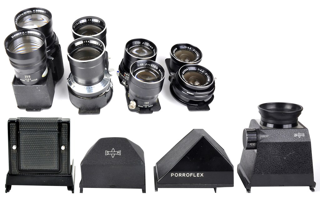 Mamiya C3 accessory lenses, left to right: 250mm, 180mm, 135mm and 55mm. Viewfinders, left to right: waist-level, pentaprism, porroflex and magnifying types