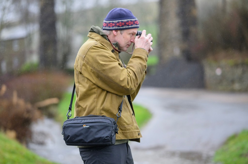 man with camera and shoulder bag