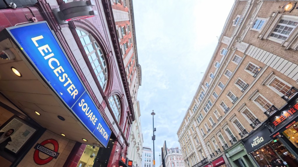Photograph of the sky above the buildings by Leicester Square Underground station