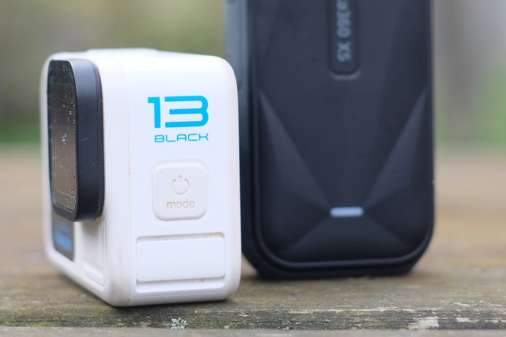 GoPro Hero 13 Black next to Insta360 X5, close up showing GoPro logo