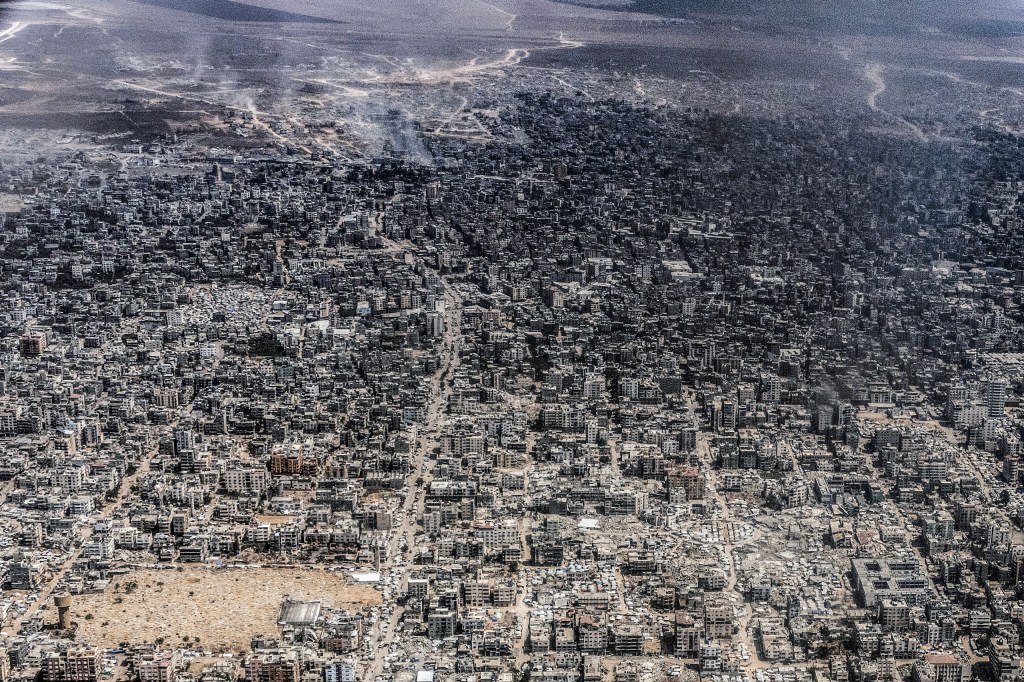 GAZA STRIP, PALESTINIAN TERRITORIES - JULY 30: An aerial view showing massive destruction and displacement in area of Gaza City photographed from a C-30 military aircraft belonging to the Royal Jordanian Air Force, July 30,2025. Airdrops of humanitarian aid were executed by the RJAF and the UAE Air Force over the war torn Gaza enclave. Image credit: Heidi Levine