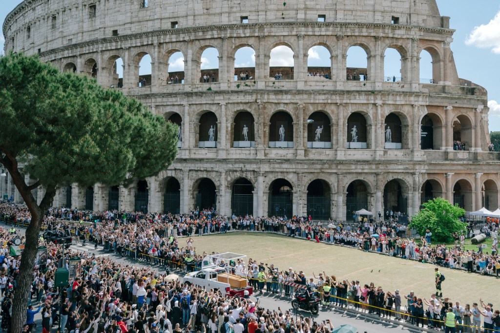 ROME, ITALY - APRIL 26: A vehicle carrying the coffin of the late Pope Francis drives by the Colosseum on April 26, 2025 in Rome, Italy. Image Credit: Andrei Pungovschi/Getty Images
