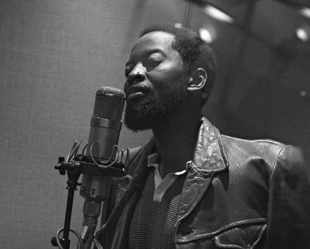 portrait of a man stood next to microphone in studio