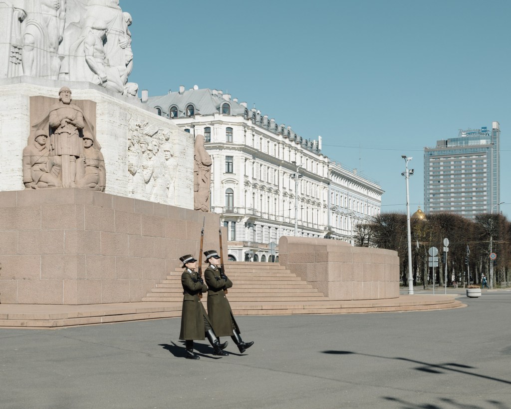 Two female soldiers walk past the Freedom Monument in central Riga during a shift change. The monument, honouring soldiers killed in the Latvian War of Independence, is guarded around the clock.
