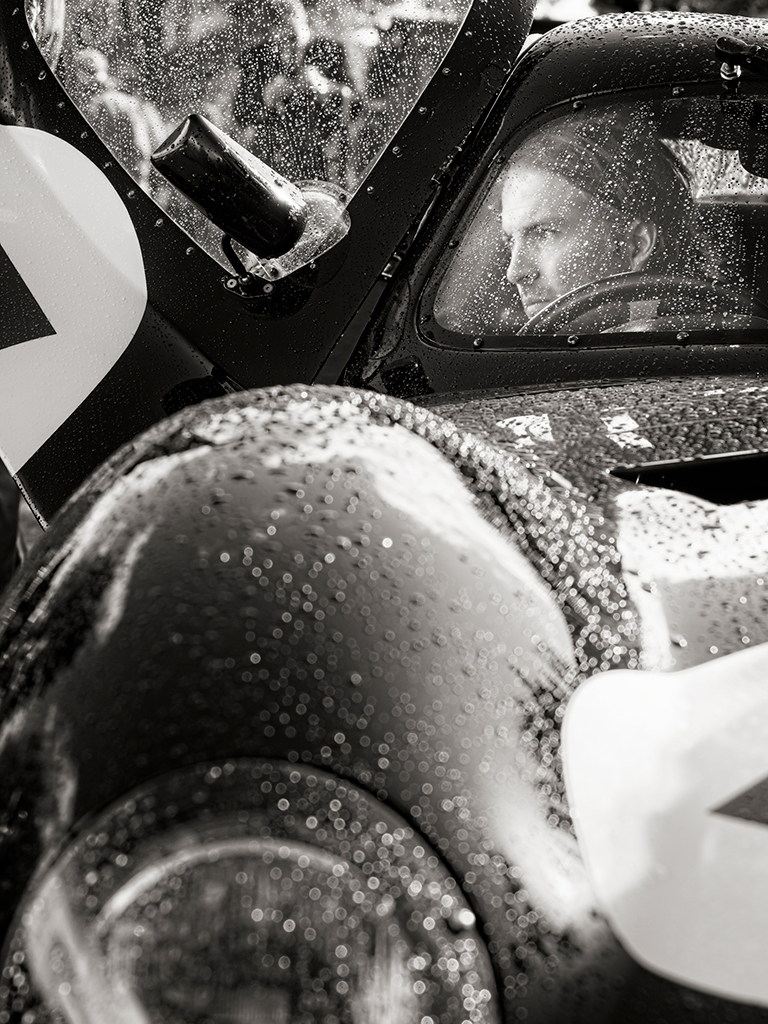 black and white portrait of a car driver through  the windscreen
