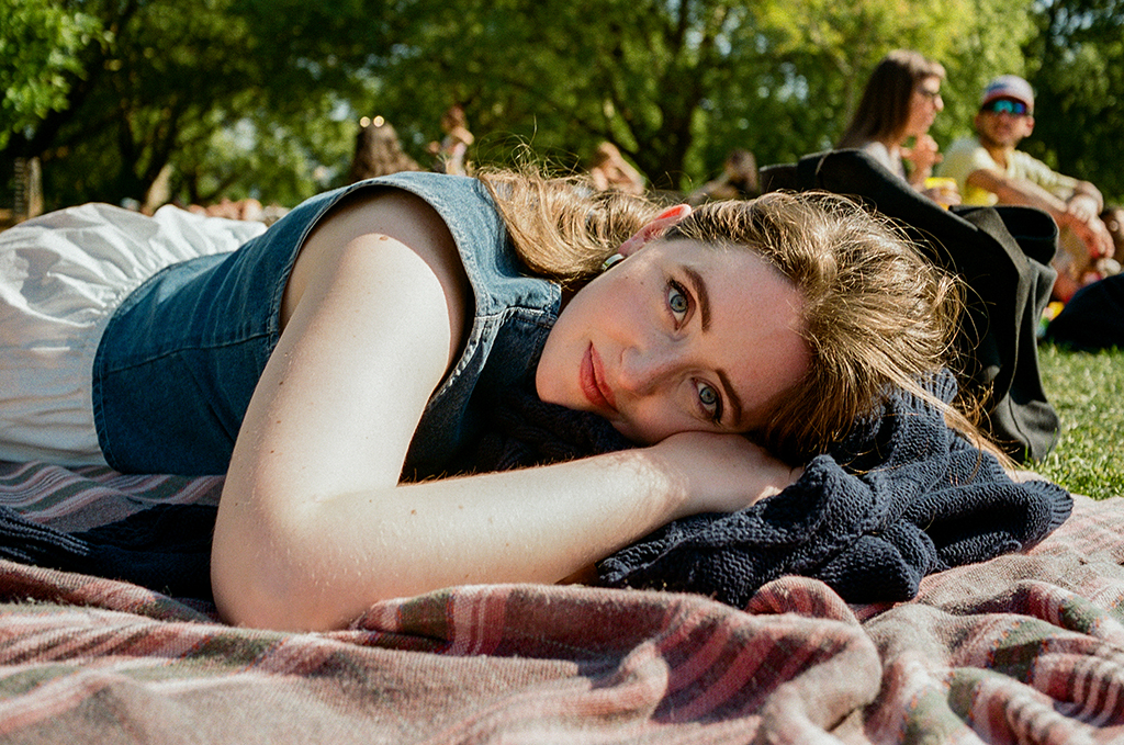 portrait of a woman lying on a blanket and looking at the camera