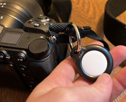 An AirTag attached to a Nikon camera
