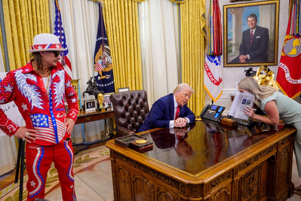 WASHINGTON, DC - MARCH 31: U.S. President Donald Trump, accompanied by entertainer Kid Rock (L), speaks with White House press secretary Karoline Leavitt (R), before signing an executive order in the Oval Office of the White House on March 31, 2025 in Washington, DC. Trump has signed an executive order against ticket scalping and reforming the live entertainment ticket industry. (Photo by Andrew Harnik/Getty Images)