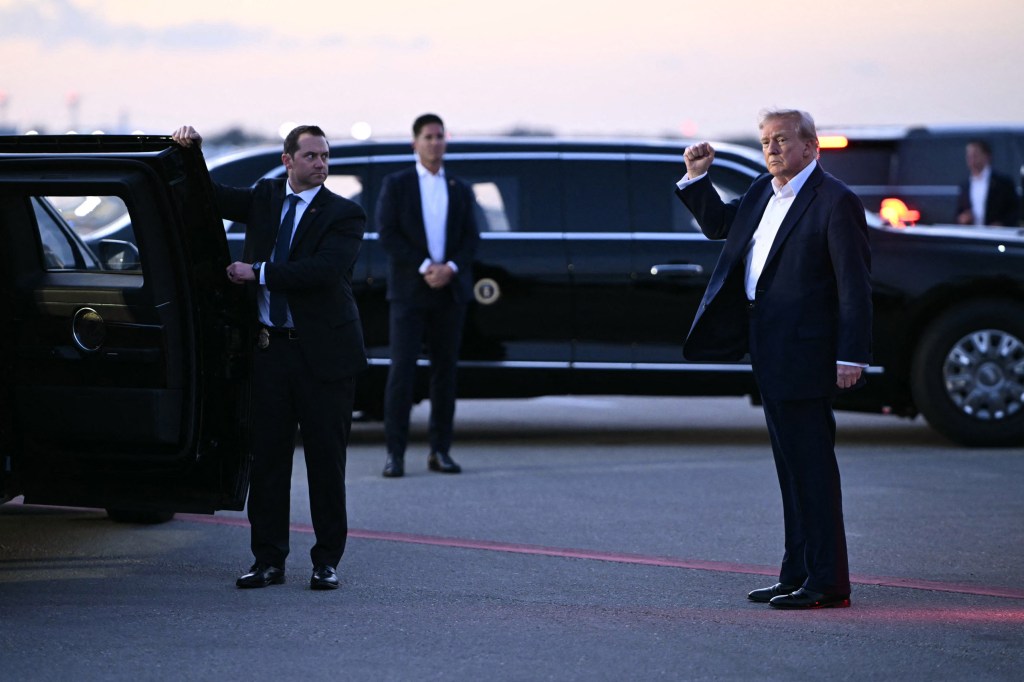 WEST PALM BEACH, FL - APRIL 11: US President Donald Trump raises a fist as he walks to get into a vehicle upon arrival at Palm Beach International Airport in West Palm Beach, Florida, on April 11, 2025. Trump is heading to Palm Beach to spend the weekend at his Mar-a-Lago resort. (Photo by Mandel NGAN / AFP) (Photo by MANDEL NGAN/AFP via Getty Images) 
