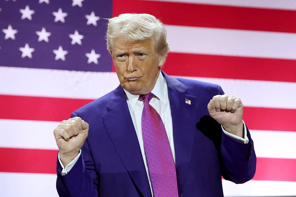 DOHA, QATAR - MAY 15: U.S. President Donald J. Trump gestures on stage as he tours the Al Udeid Air Base on May 15, 2025, in Doha, Qatar. Trump is on the third day of his visit to the Gulf to underscore the strategic partnership between the United States and Qatar, focusing on regional security and economic collaboration. (Photo by Win McNamee/Getty Images)