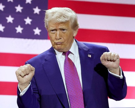 DOHA, QATAR - MAY 15: U.S. President Donald J. Trump gestures on stage as he tours the Al Udeid Air Base on May 15, 2025, in Doha, Qatar. Trump is on the third day of his visit to the Gulf to underscore the strategic partnership between the United States and Qatar, focusing on regional security and economic collaboration. (Photo by Win McNamee/Getty Images)
