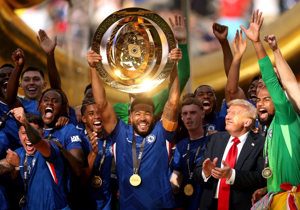 EAST RUTHERFORD, NEW JERSEY - JULY 13: Reece James #24 of Chelsea FC lifts the FIFA Club World Cup trophy after their team's victory as U.S. President Donald Trump reacts following the FIFA Club World Cup 2025 Final match between Chelsea FC and Paris Saint-Germain at MetLife Stadium on July 13, 2025 in East Rutherford, New Jersey. (Photo by Carl Recine - FIFA/FIFA via Getty Images)
