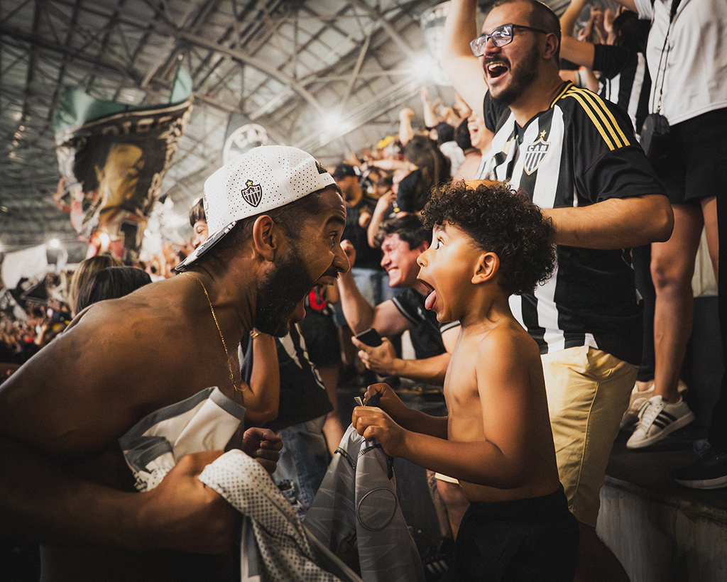 Football, Gold Award, Black & White Passion by Luis Amaral. Emotion that bursts in the moment and finds itself in someone else — the kind of feeling football turns into its own language, especially in the father-and-child bond. Image: Luis Amaral