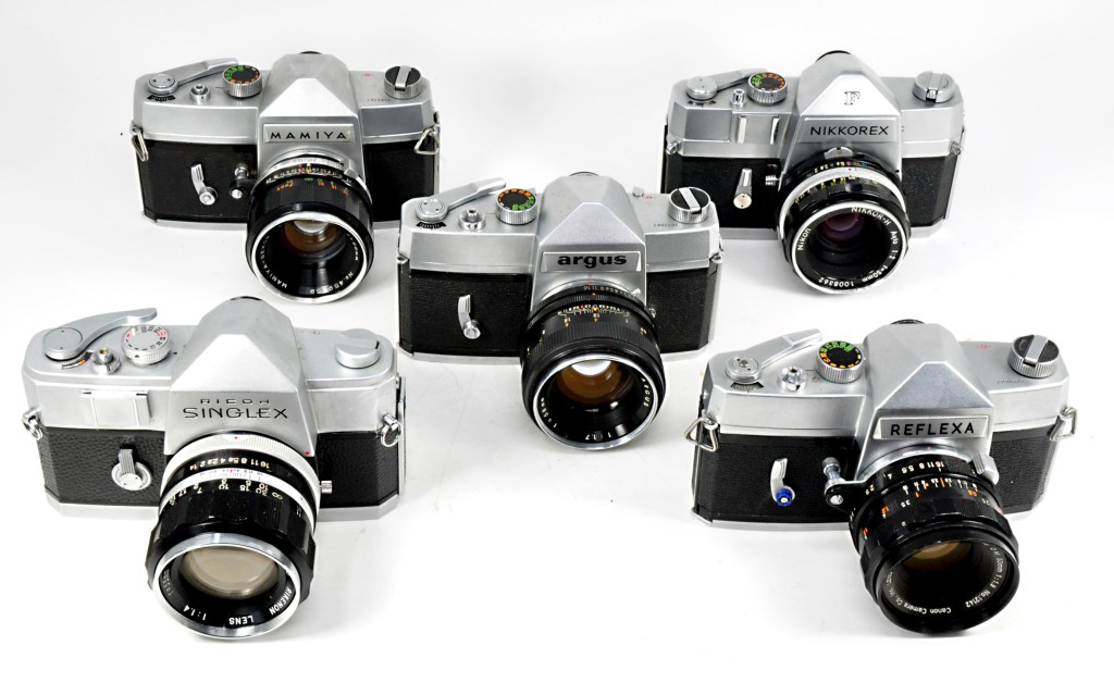 Variations on one camera: Rear, Mamiya Prismat NP and Nikkorex F; centre, Argus 35; front, Ricoh Singlex and Reflexa
