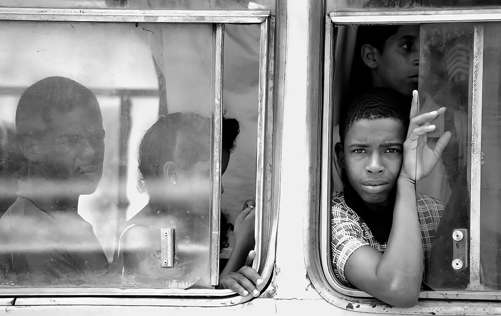 young boy looking out window