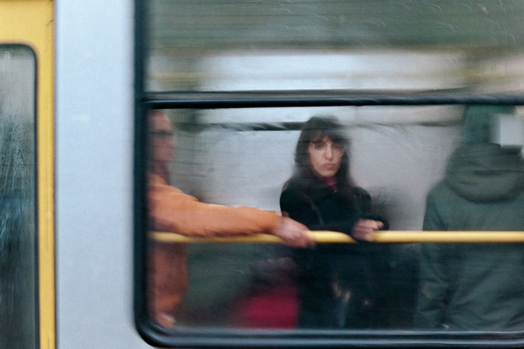 woman looking out of a foggy train window