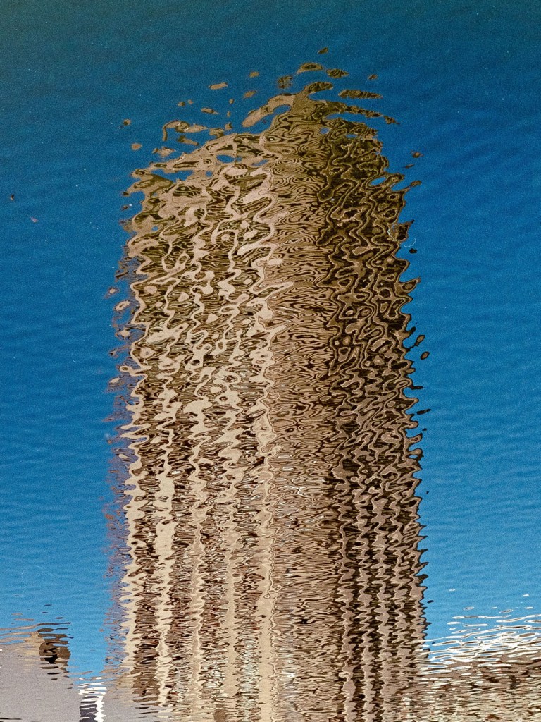 reflection of a apartment block building in a puddle