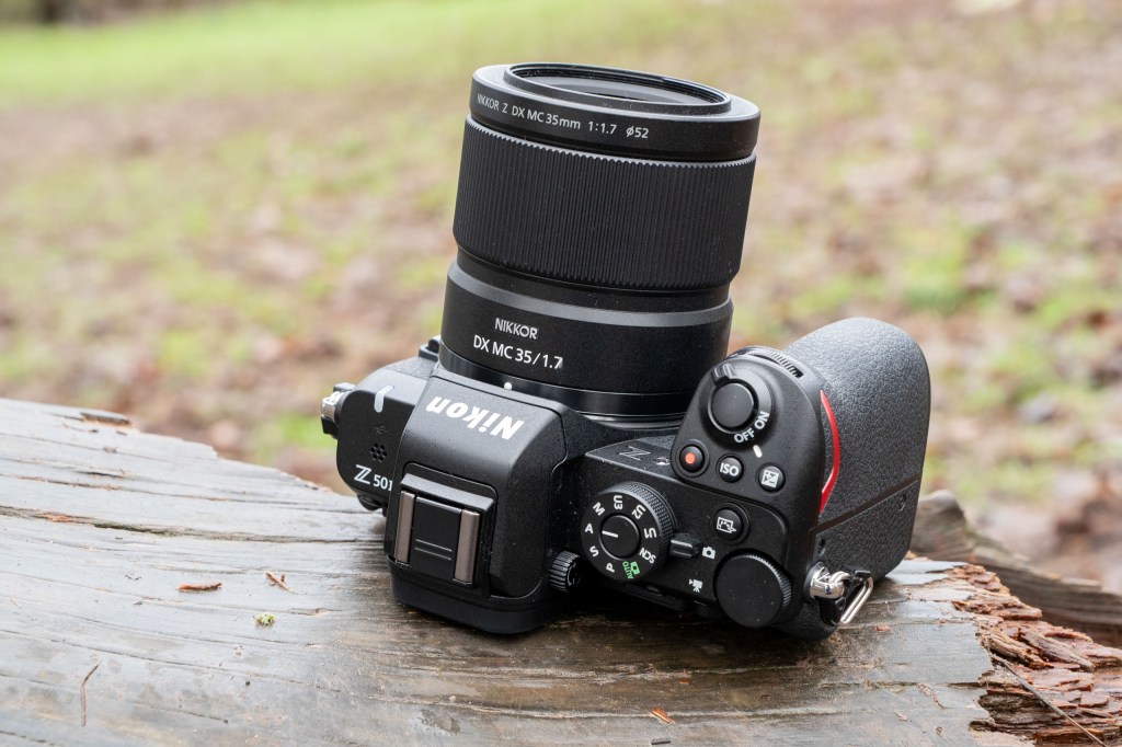 The Nikkor 35mm Macro lens attached to a Nikon Z50 II on a log
