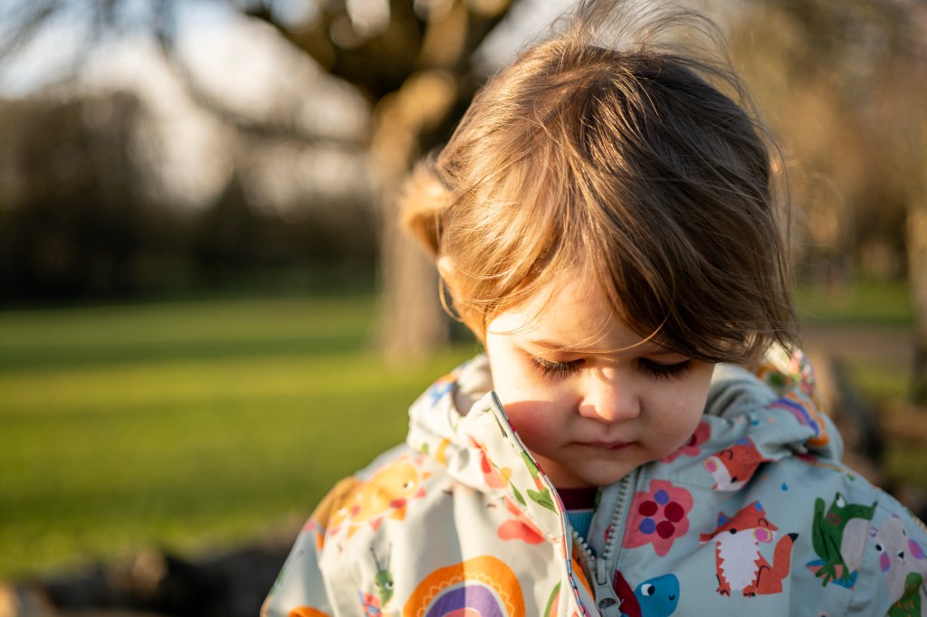 A small child looking down at the floor