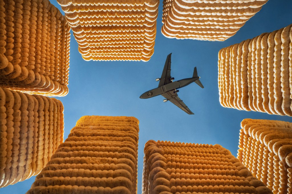 sill life photo of custard creams stacked up with plane overhead in the middle