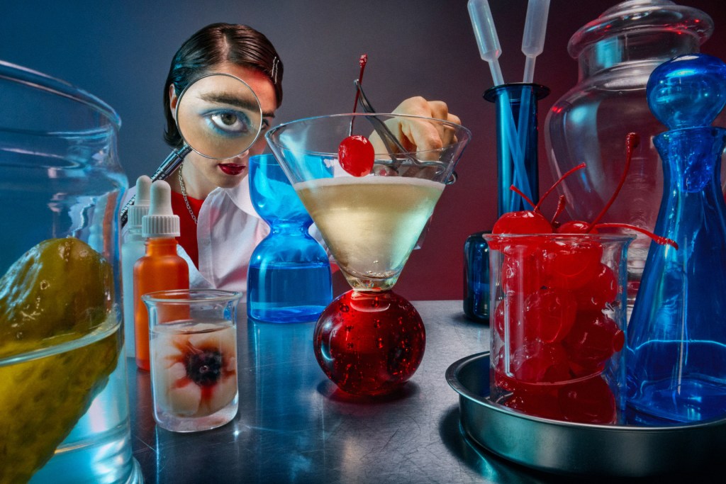 creative food portrait of a woman placing a glacier cherry into a jar in a lab