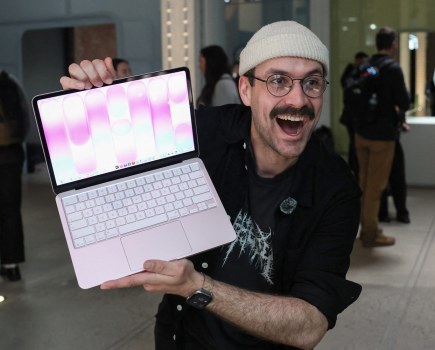 A man holds the new Apple MacBook Neo. Photo by TIMOTHY A. CLARY / AFP via Getty Images