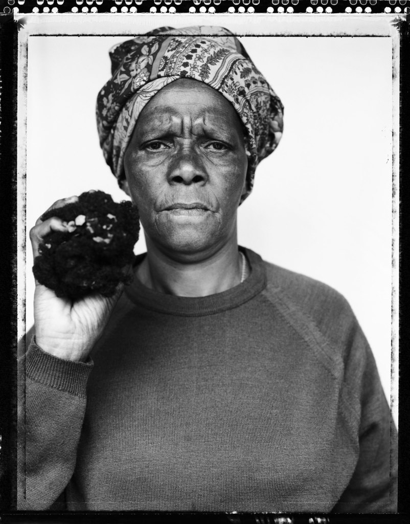 Joyce Mtimkulu. Zwide Port Elizabeth 1997 holding the hair of her dead son. She kept her son’s hair for 20 years. It fell out when he was fed rat poison by the South African security police. She kept the hair in a black plastic bag which she took to the hearings so that it could be held up as evidence. Image: Jillian Edelstein