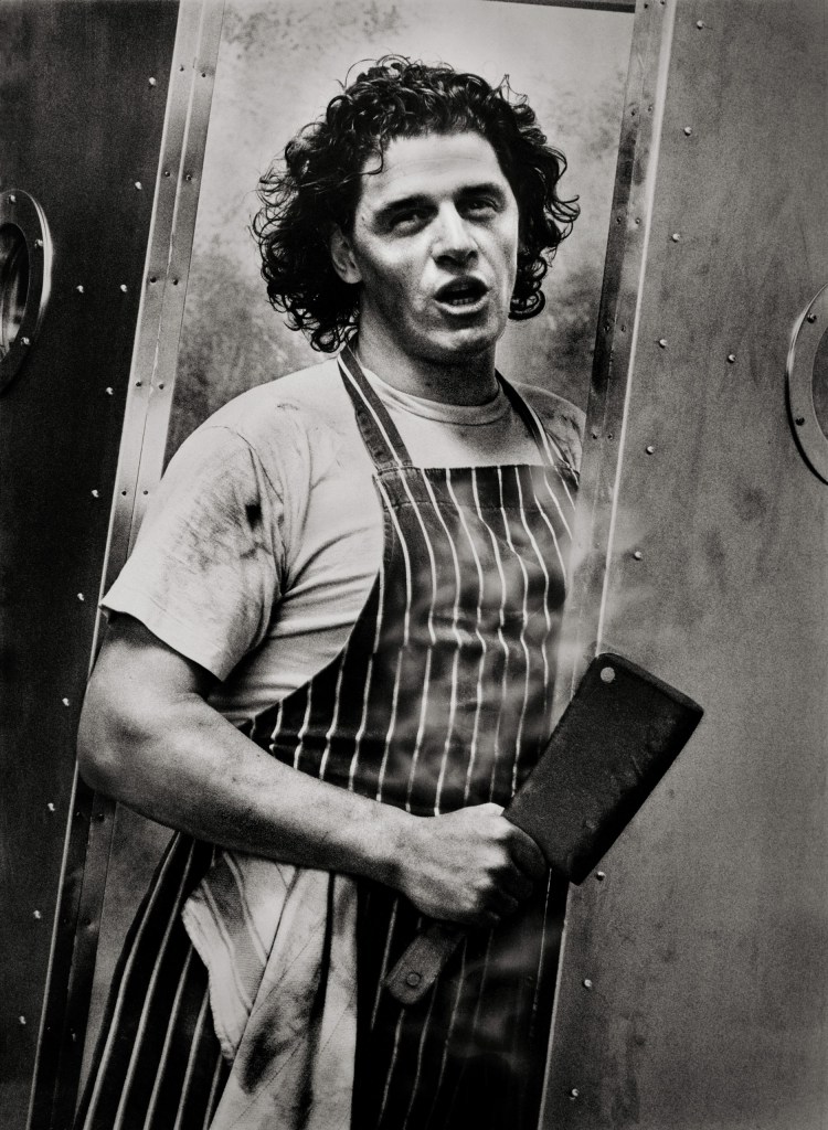 black and white photo of a man holding Meat Cleaver