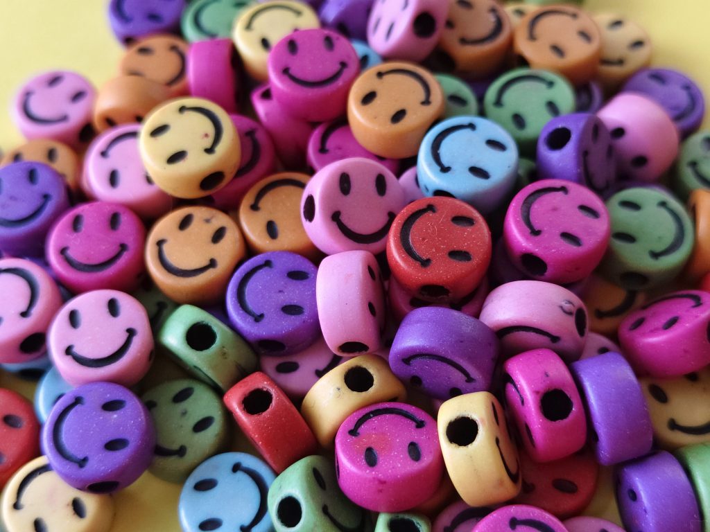 Brightly coloured beads on a yellow background