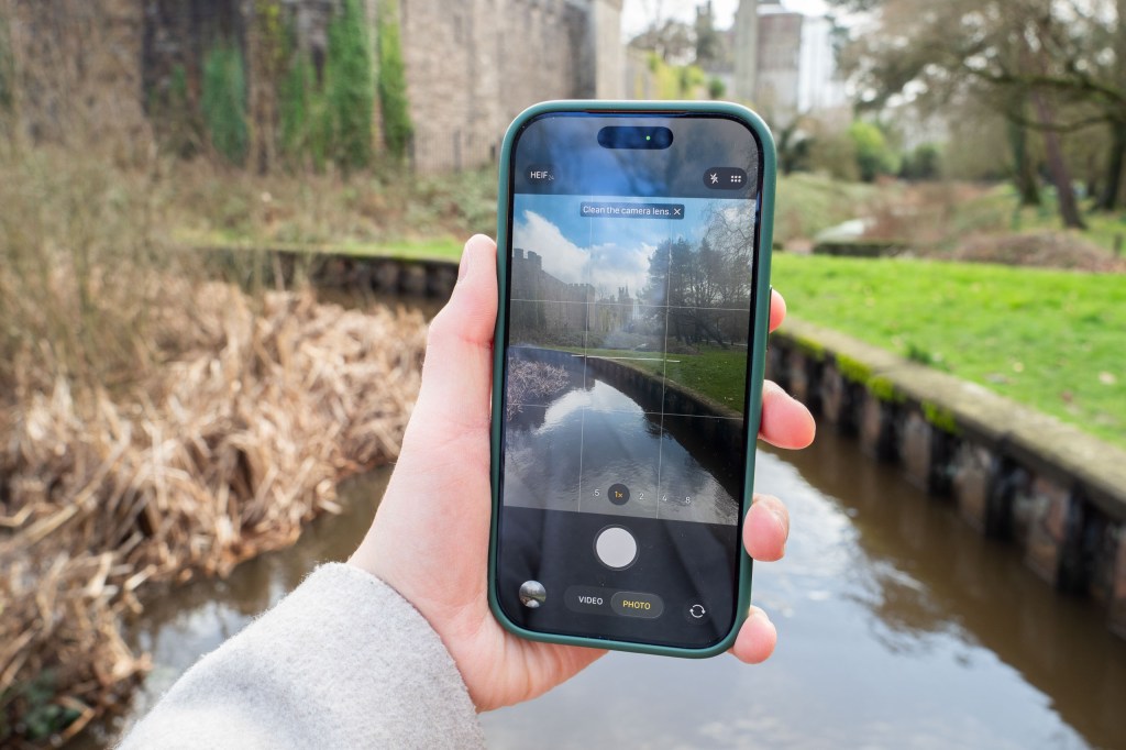 An iPhone 17 Pro displaying the clean lens warning
