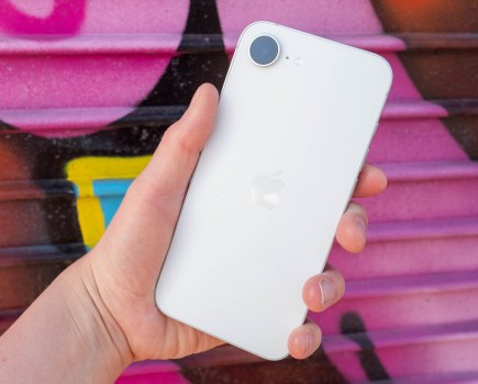 An iPhone 17e in front of a vibrant graffitied background