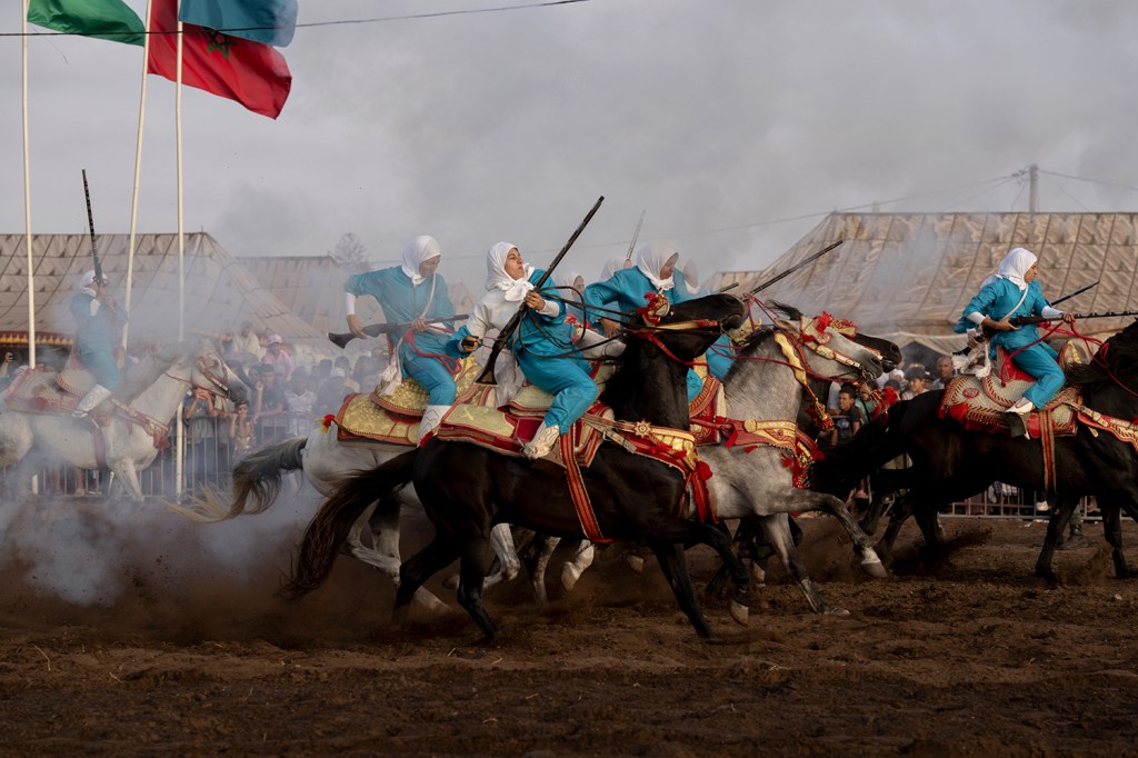 
Noura attempts to control her horse after firing, the most dangerous part of the performance. Riders risk injury from gunpowder or falling and being trampled. Sidi Rahal, Morocco, 8 August 2025.
