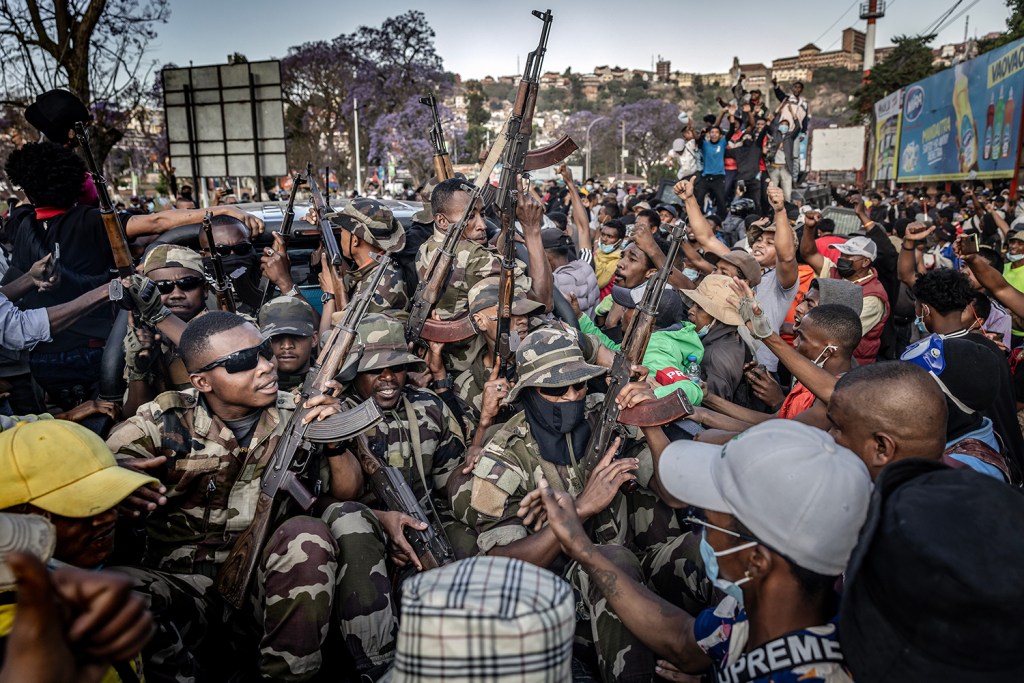 Members of the CAPSAT military unit ride a pickup truck as protesters celebrate their arrival, following clashes between demonstrators and security forces. Antananarivo, Madagascar, 11 October 2025.
