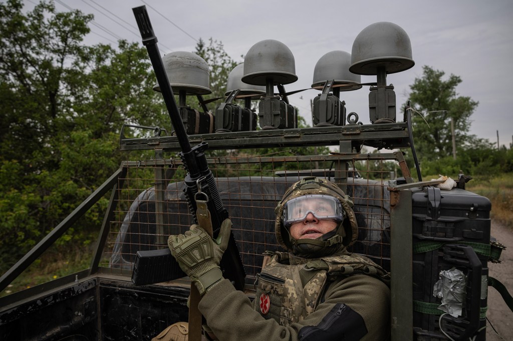 A soldier from Ukraine’s 93rd Brigade scans for Russian FPV drones while speeding through Kostyantynivka, a strategic gateway to Ukraine’s last major defensive belt in Donetsk. Kostyantynivka, Ukraine, 19 June 2025.